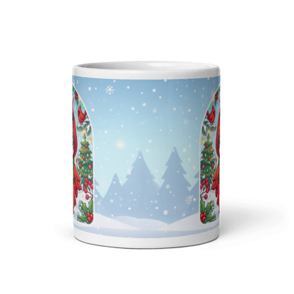 Back of the cat cardinal mug showing a pale blue winter scene with snowy pine trees
